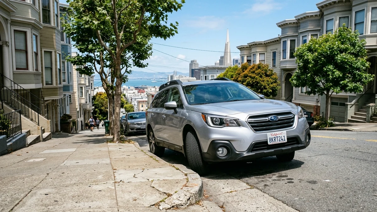 Vehicle parked securely on a steep city incline with front wheels turned toward the curb